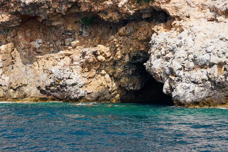 Cave at the bottom of sea cliffs. Alanya, Turkey.の写真素材