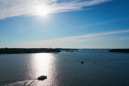 A boat in sunlight on a sunset. Backlight. Archipelago near Naantali, Finland.の写真素材