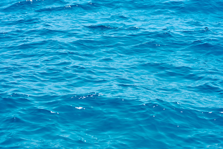 Waving clear blue sea water background.の写真素材