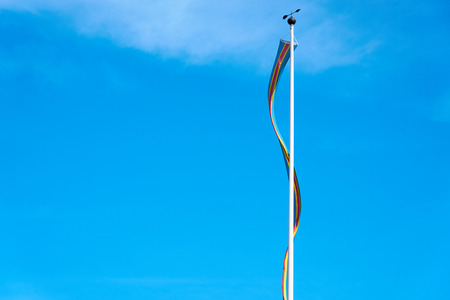 A flag of Ãland Islands, Finland against a blue sky.の写真素材