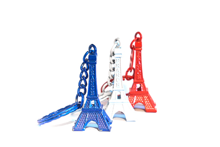 Eiffel tower souvenir keychains in colors of flag of France isolated on white.の写真素材
