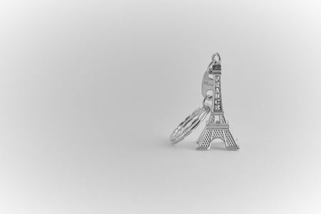 Silver color Eiffel tower souvenir keychain. Copy space for text.