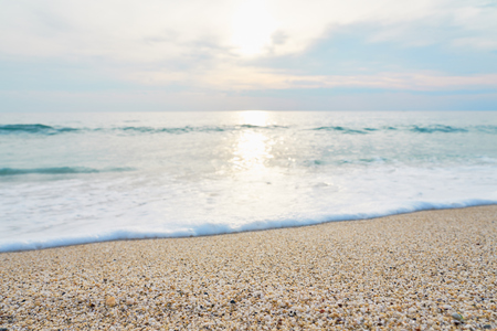 Waves with foam hitting sand on the tropical beach texture.の写真素材