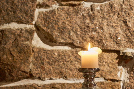 Candle with blurred granite wall on a background.の写真素材