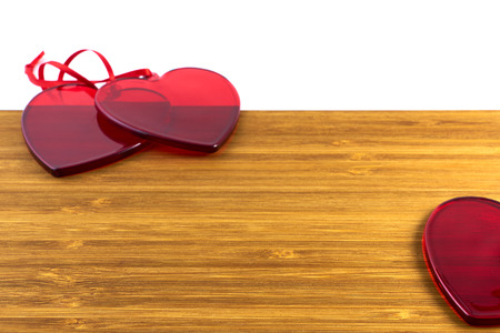 Red glass hearts on wooden background. Valentine's day concept. Copy space.の写真素材