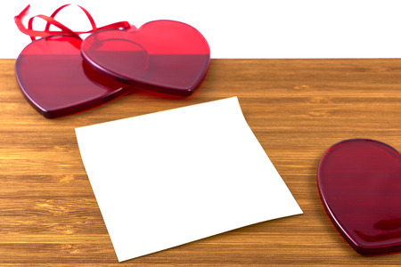 Red glass hearts on wooden background. Valentine's day concept. Copy space.の写真素材