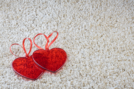 Red glass hearts on a carpet love and Valentine concept. Copy space.の写真素材