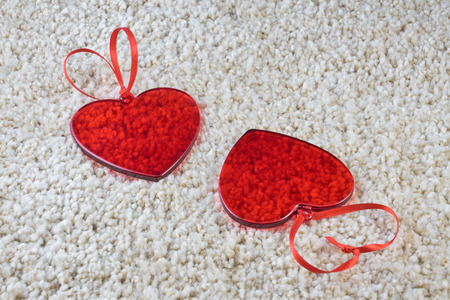 Red glass hearts on a carpet love and Valentine concept. Copy space.の写真素材