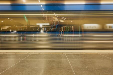 Moving Metro train on a station background.