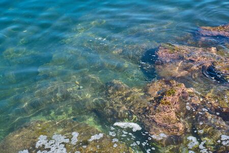 Stone beach of mediterranian sea, sea coast. Natural background.
