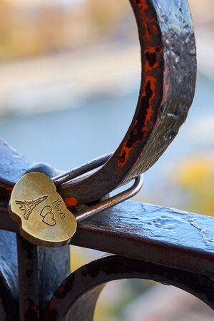 Romantic lock with Eiffel tower and hearts against a blurred city of Paris on a background. Love concept.の写真素材