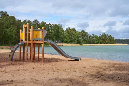 Playground slide on sandy beach.の写真素材
