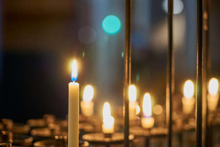 Candles in the church at close range with a blurred background.の写真素材