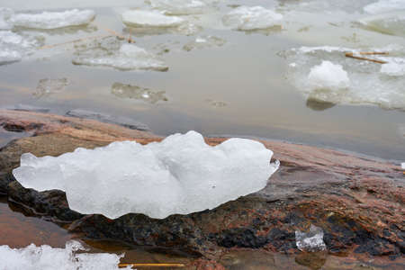 Ice on a rocky shore in winter time.