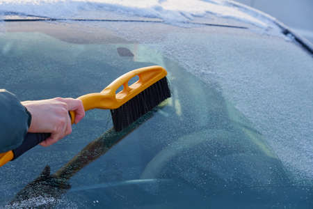 Cleaning the windshield of the car from the ice. Copy space.の写真素材