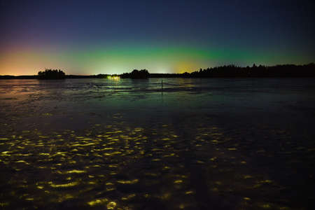 Northern Lights over the frozen lake in Littoinen, Finland. Copy space.の写真素材
