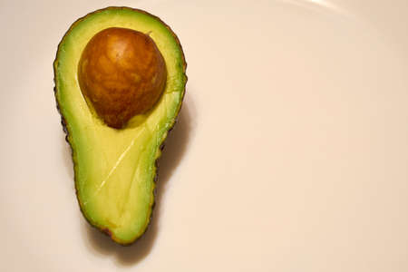 Fresh ripe avocado in a cut on a white plate.の写真素材