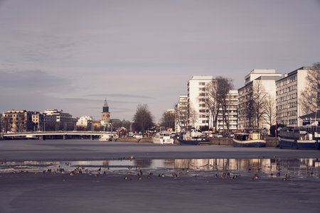 TURKU, FINLAND- March 23, 2021: View of the Turku Cathedral and the Aura river on sunset.の写真素材