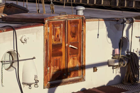 Vintage wooden door on an old yacht in sunlight.の写真素材