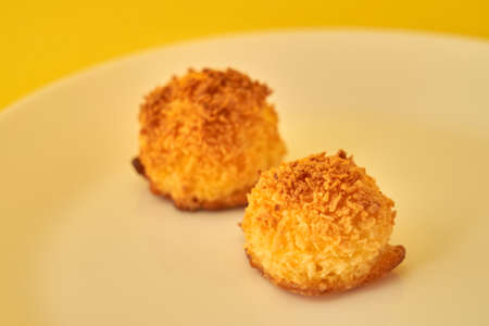 Coconut cookies on a white plate with space for text.