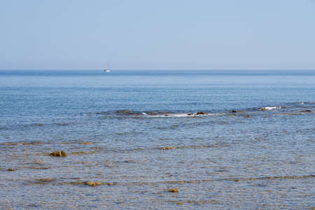 The coast of the Aegean Sea in Crete with a horizon in the background.