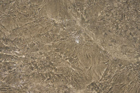 Surface of clear water on tropical sandy beach in Crete Greece