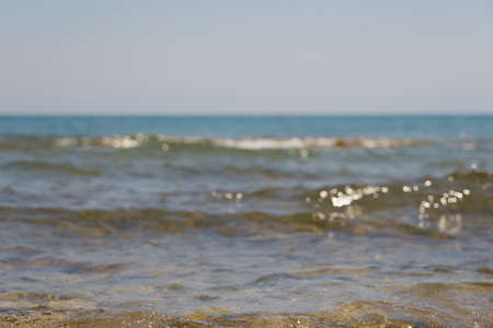 Waves with foam on Aegean sea coast in Crete Greece