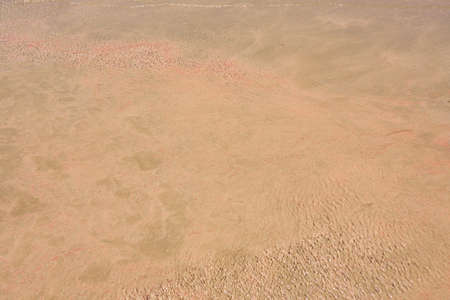 Clear waves and colorful sand on tropical sandy beach in Crete Greece