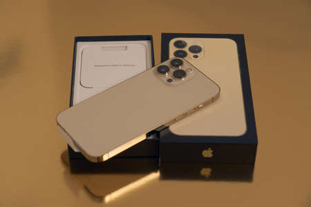 Turku, Finland - September 26, 2021: New iPhone 13 pro max in gold with box