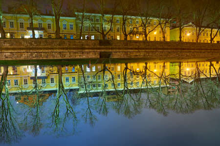 The night view of Aura river in Turku, Finland with houses on a backgroundの写真素材