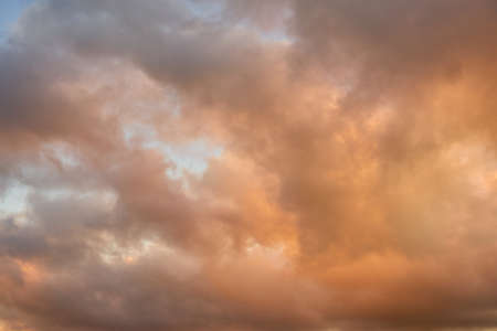 Colorful clouds in the setting sky as a background