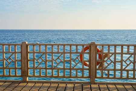 Lifebuoy on railings with the Red Sea in the background.の写真素材
