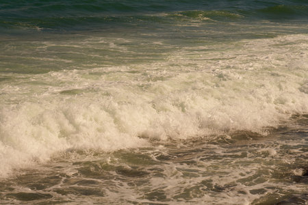 Waves with foam on the Caribbean coast in Mexico.の写真素材