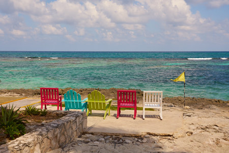 Colorful chairs on the shores of the Caribbean Sea in Mexico.の写真素材