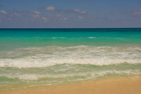 Waves with foam on the Caribbean coast in Mexico.の写真素材