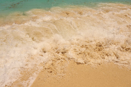 Waves with foam on the Caribbean coast in Mexico.の写真素材