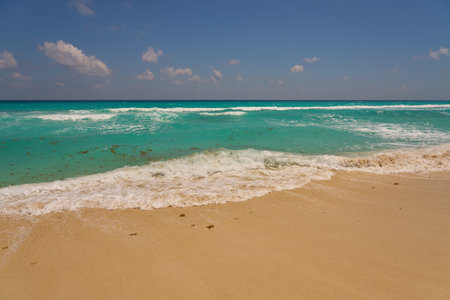 Waves with foam on the Caribbean coast in Mexico.の写真素材
