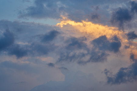 Clouds in the sky, illuminated by the sun at sunsetの写真素材