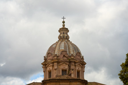 The dome of an ancient Roman building against the background of a cloudy skyの写真素材