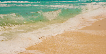 Waves with foam on the Caribbean coast in Mexico
