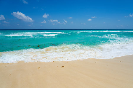 Waves with foam on the Caribbean coast in Mexicoの写真素材