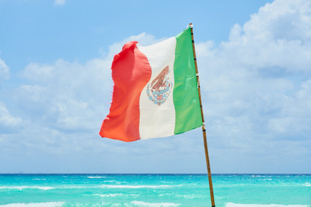 The flag of Mexico against the background of the Caribbean Seaの写真素材