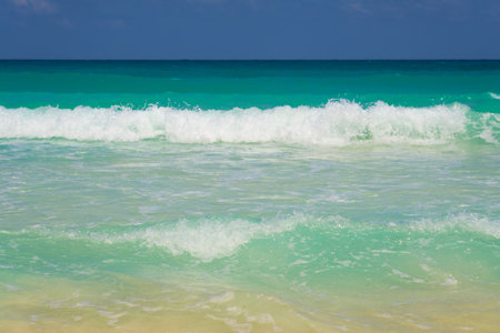 Waves with foam on the Caribbean coast in Mexicoの写真素材