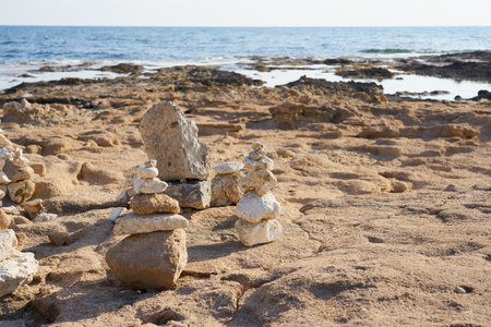 Figures made of stones on the shores of the Mediterranean Seaの写真素材