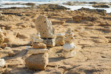 Figures made of stones on the shores of the Mediterranean Seaの写真素材
