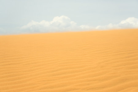 Sand dune in the desert with clouds in the backgroundの写真素材