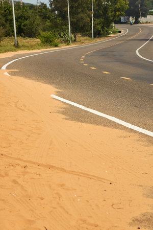 Desert sand steps on an asphalt roadの写真素材