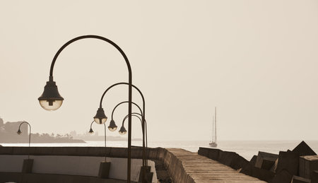 Lanterns on the promenade against the background of the sea.の写真素材
