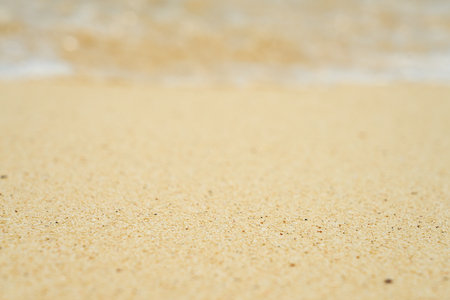 Waves and foam on a tropical sandy beach.の写真素材