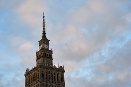 Palace of Culture and Science in Warsaw, Poland against a cloudy sky.